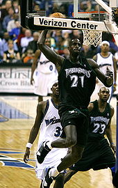 Derrick Rose holds a basketball