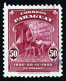 A postage stamp of Paraguay showing a 19th century man sitting in a chair with books lining the wall behind him. The cost is 50 centavos.