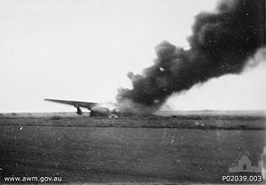 A USAAF B-24 Liberator on fire at Broome Airfield following the attack.